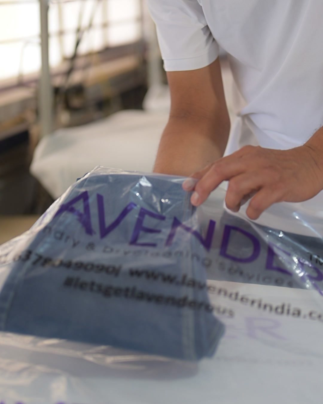A dry-cleaned garment folded and sealed into Lavender packaging