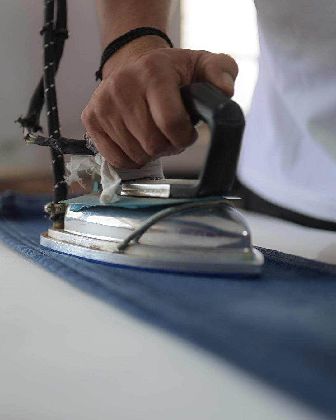 Close-up of a steam press finishing a freshly washed garment
